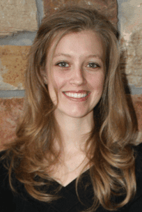 Smiling woman with long hair in front of a stone wall, featured image for an article on discernment counseling